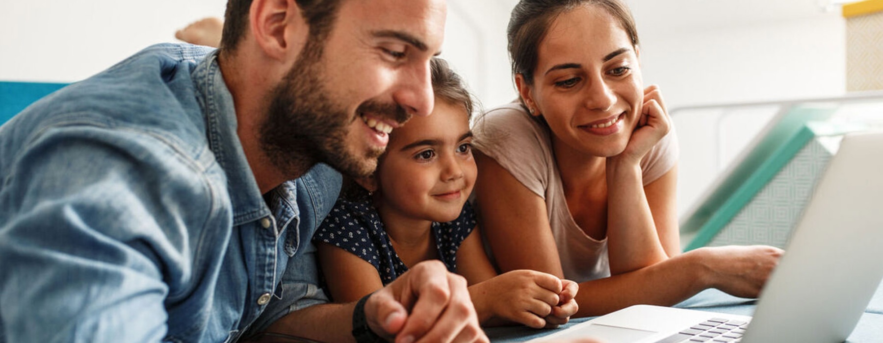 a family looking at a laptop