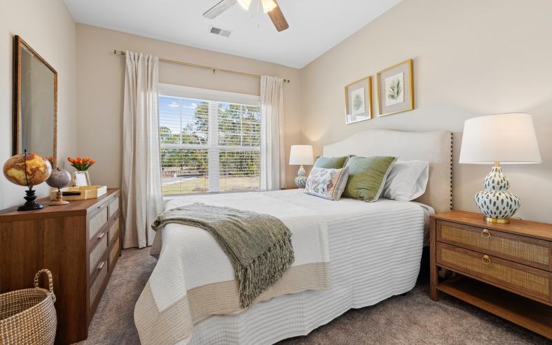 a bedroom with a bed and a fan